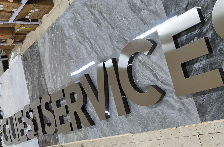 GUESTSERVICES_Metal non-illuminated brushed metal letter sign for a business